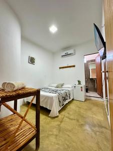 a bedroom with a bed in a white room at Pousada Zoom Jericoacoara in Jericoacoara