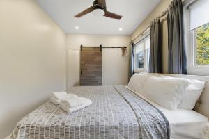 a bedroom with a bed and a ceiling fan at Redwood Suite - NOTL Prime Location GETAWAY in Niagara-on-the-Lake