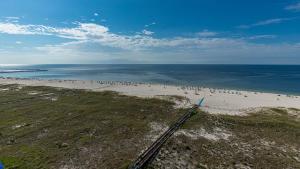 an aerial view of a beach with a group of people at Phoenix VI 61204 in Orange Beach