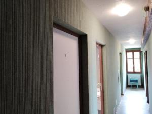 a hallway with a white door in a room at Chambre La Charolaise in Aubessagne