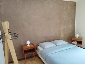 a bedroom with a bed and two night stands at Chambre La Charolaise in Aubessagne