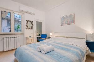 a bedroom with a large bed with towels on it at Sea Whisper Volastra in Volastra