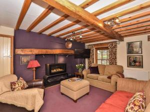 a living room with a couch and a fireplace at 4 Bed in Llandudno Junction oc-58301 in Llandudno Junction