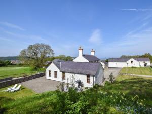 a large white house in a green field at 4 Bed in Llandudno Junction oc-58301 in Llandudno Junction