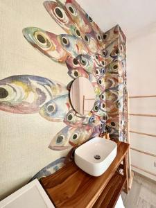 a bathroom with a mirror and a butterfly wall at Aquarium - Villa con accesso al mare - parcheggio in San Vito +39 photos