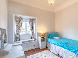 a bedroom with a bed and a window at 2 Bed in Holt oc-ncc66 in Blakeney