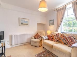 a living room with a couch and a tv at 2 Bed in Holt oc-ncc66 in Blakeney +4 photos