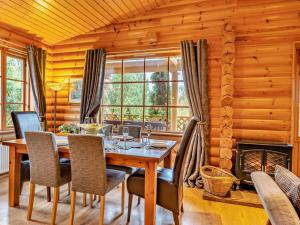 a dining room with a table and chairs and a fireplace at 3 Bed in Dunsyre oc-lk15m in Walston