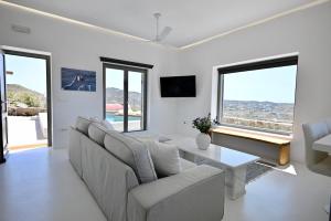 a living room with a couch and a table at Sunwave Mykonos Villa in Mykonos
