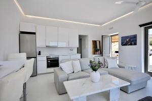 a living room with a couch and a table at Sunwave Mykonos Villa in Mykonos
