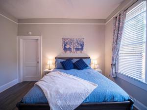 a bedroom with a blue bed with two blue pillows at Marietta Square's Home Away! in Marietta