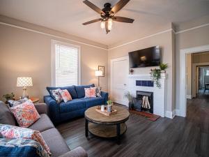 a living room with a blue couch and a fireplace at Marietta Square's Home Away! in Marietta