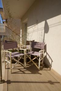 a couple of chairs sitting on a porch at Room45 in Marzamemi