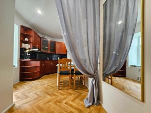 a kitchen and dining room with a table and a curtain at Old Town Cathedral Views - Steps from Dome Square -Friends & Family stay in Riga +64 photos
