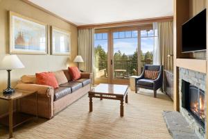 a living room with a couch and a fireplace at 5058 - Grand Suncadia Mountain Lodge with Hot Tub and Views in Cle Elum