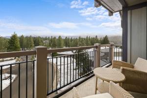 a balcony with chairs and a view of trees at 5058 - Grand Suncadia Mountain Lodge with Hot Tub and Views in Cle Elum