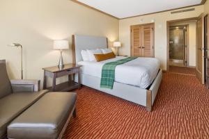 a hotel room with a large bed and a couch at 5058 - Grand Suncadia Mountain Lodge with Hot Tub and Views in Cle Elum