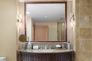 a bathroom with a sink and a large mirror at 5058 - Grand Suncadia Mountain Lodge with Hot Tub and Views in Cle Elum +26 photos