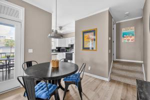 a kitchen and dining room with a table and chairs at 221 Olive Way in Saint Simons Island
