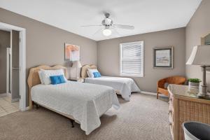 a bedroom with two beds and a window at 221 Olive Way in Saint Simons Island