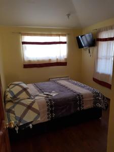 a bedroom with a bed and a window and a television at Very cute and spacious complete house with a fireplace! in Teziutlán