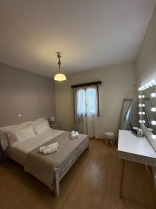 a bedroom with a bed with two towels on it at Olea House in Elia Laconias