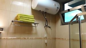 a bathroom with a blow dryer and towels on a wall at Delano Hotel in Bahir Dar +21 photos