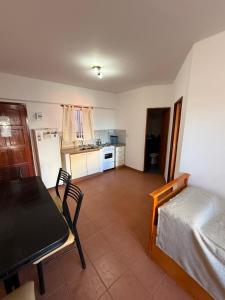 a living room with a table and a kitchen at Departamentos Li-Del in Monte Hermoso