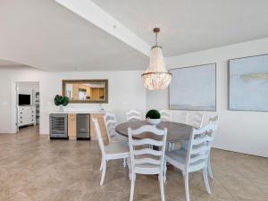 a kitchen and dining room with a table and chairs at Caribe The Resort #C702 in Perdido Key +35 photos