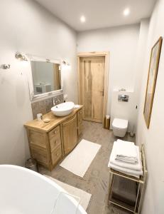 a bathroom with a sink and a mirror and a toilet at Ostoja nad jeziorem Żywki in Żywki +54 photos