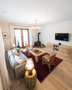 a living room with a couch and a table at Ostoja nad jeziorem Żywki in Żywki