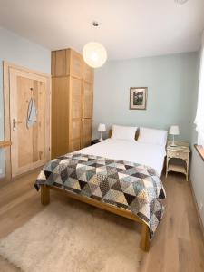 a bedroom with a bed with a quilt on it at Ostoja nad jeziorem Żywki in Żywki