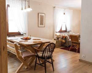 a kitchen and dining room with a table and chairs at Ostoja nad jeziorem Żywki in Żywki