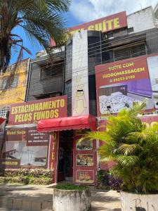 a building with signs in front of it at Hotel Suíte in Brasília
