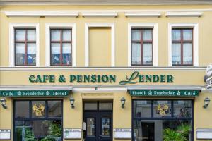 a building with a cafe and passion lender sign on it at Hotel-Pension Lender in Bad Freienwalde