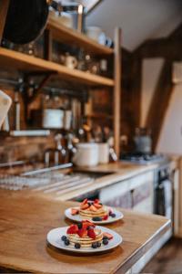 two plates of food on a counter in a kitchen at Sky Cabin. Cosy Forest Log Cabin 3 night minimum in Wareham