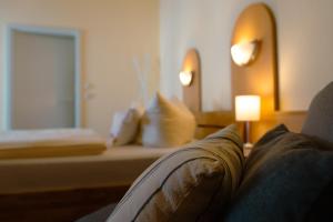 a living room with a couch and a window at Hotel-Pension Lender in Bad Freienwalde