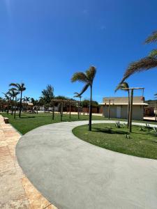 a walkway with palm trees in a park at Pousada Zoom Jericoacoara in Jericoacoara