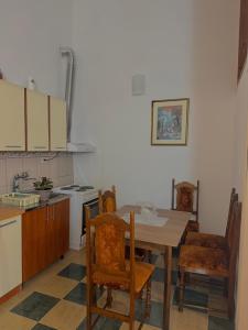 a kitchen with a table and chairs in a kitchen at Radovic Apartmani in Herceg-Novi +15 photos