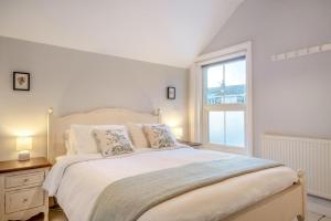 a white bedroom with a large bed and a window at 2 Bed in Bembridge oc-p34174 in Bembridge