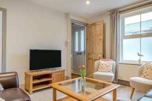 a living room with a television and a coffee table at 2 Bed in Bembridge oc-p34174 in Bembridge