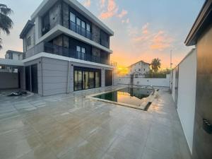 a house with a swimming pool in front of it at Ephesus in Belek