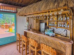 a bar in a restaurant with chairs and a truck at Canela Mountain Villa Hotel in Salento