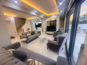 a living room with couches and chairs and a table at Ephesus in Belek