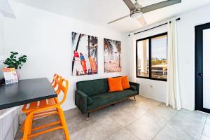a living room with a green couch and a table at Tropical Getaway in Aguadilla