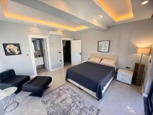 a bedroom with a bed and a living room at Ephesus in Belek