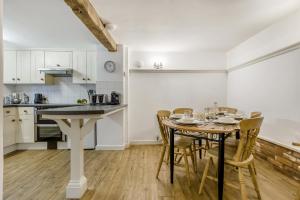 a kitchen and dining room with a table and chairs at 3 Bed in Stratton Strawless oc-w34832 in Stratton Strawless