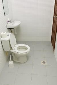 a bathroom with a toilet and a sink at JOJO Staycations in Rungiri +8 photos