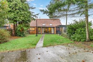 an exterior view of a house with a yard at 3 Bed in Stratton Strawless oc-w34832 in Stratton Strawless