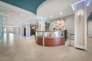 a lobby with a counter in the middle of a building at Oceanview Studio w/kitchen, pool, tiki bar in Daytona Beach +48 photos